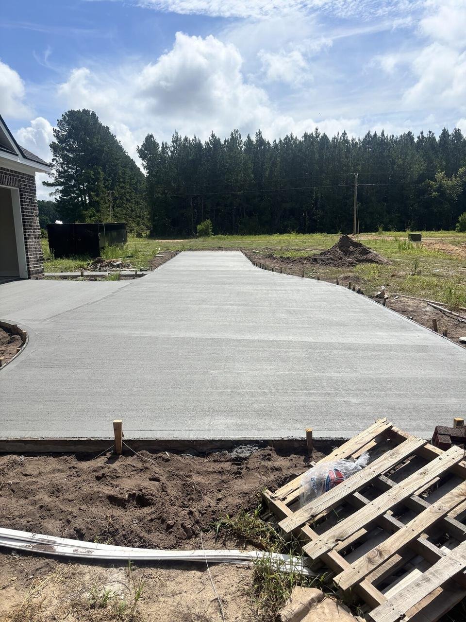 Long finished concrete driveway in the pines