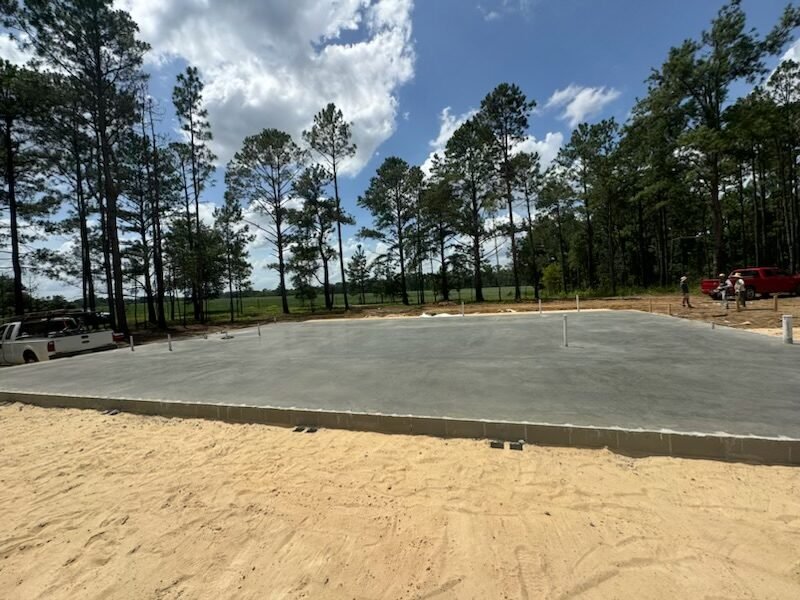 Large commercial concrete slab with trucks nearby